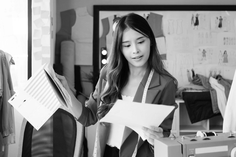 Business woman holding designs and papers