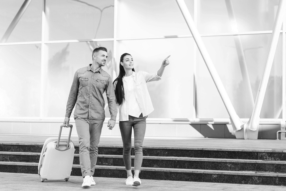 Two people walking in an urban space pointing at something they have noticed