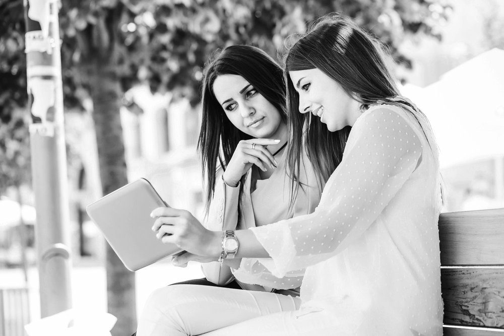 Two women looking at a laptop screen